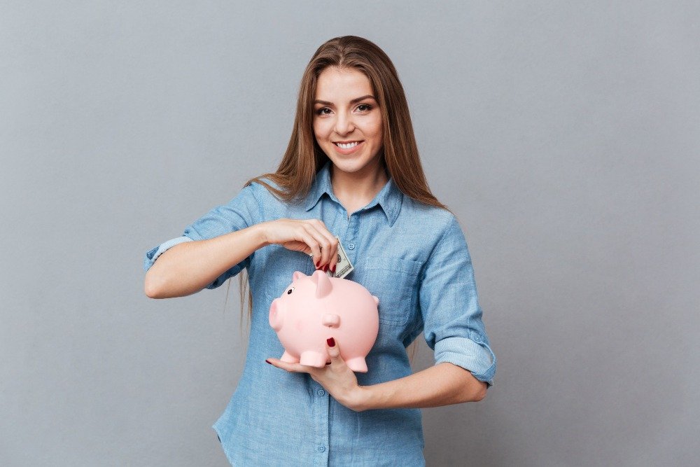 girl saving in piggy bank